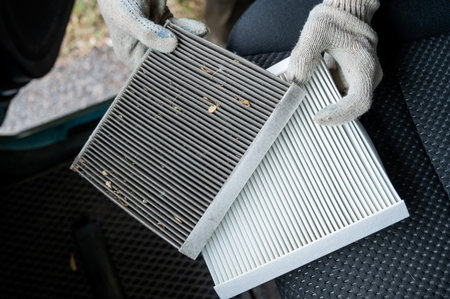 The master changes the cabin air filter of the car.の写真素材