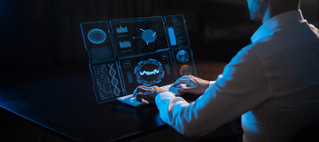Caucasian man sitting in the dark in front of a virtual menu and typing on a keyboard.