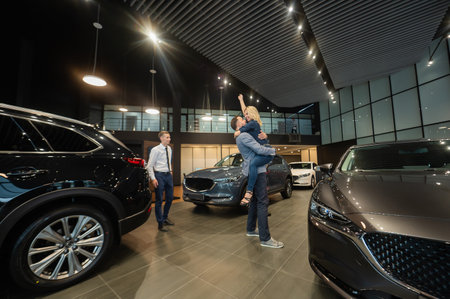 The seller helps a caucasian couple to choose a car.の写真素材