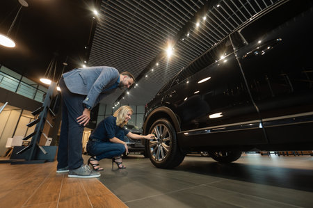 Caucasian couple chooses a new car in a car dealership.の写真素材
