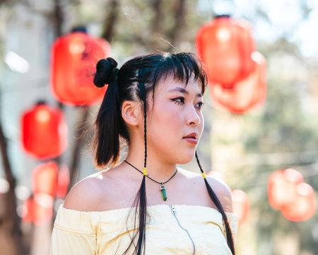 Portrait of an Asian woman against the background of Chinese lanterns.の写真素材
