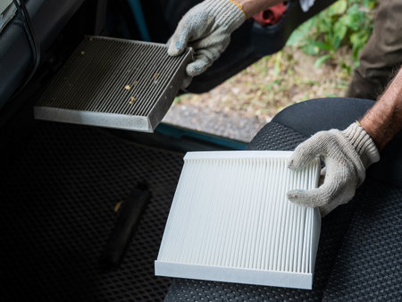 The master changes the cabin air filter of the car.の写真素材