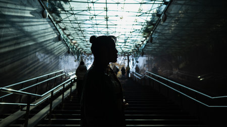 Portrait of a young Asian woman posing in the subway near the stairs.の写真素材