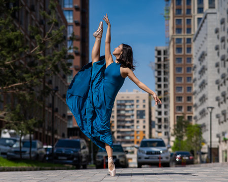Beautiful Asian ballerina dancing outdoors. Urban landscapeの写真素材