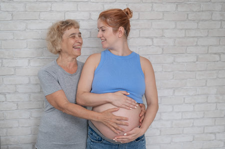 Elderly woman and her adult pregnant daughter