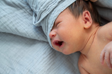 A small newborn boy is crying.Small baby 1 week old