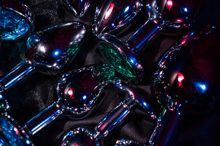 Lots of metal anal plugs in neon pink purple lightの写真素材