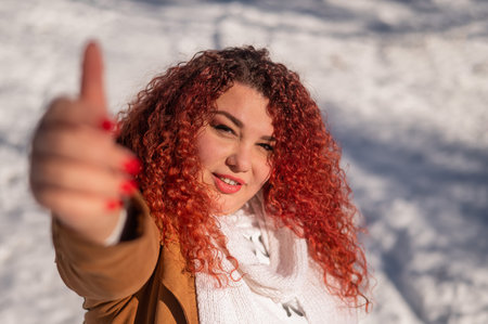 Portrait of a smiling chubby red-haired woman on a walk in winter