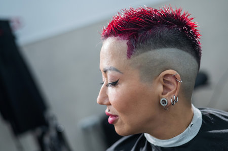 Asian woman dyeing her hair pink at the barbershopの写真素材