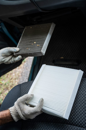 The master changes the cabin air filter of the carの写真素材