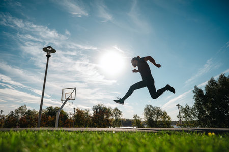 Caucasian man jumping with high hip raise outdoorsの写真素材