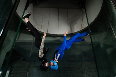 A man and a woman enjoy flying together in a wind tunnel. Free fall simulator.の写真素材