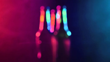 Three bottles of beer spinning in a blue-pink mistの写真素材