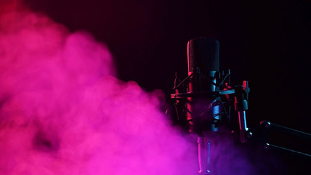 Professional microphone in pink smoke on a black backgroundの写真素材