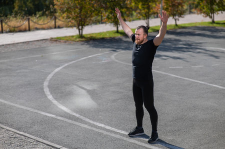 Bearded man doing exercises outdoors
