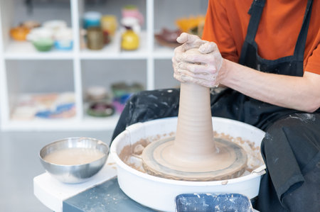 Close-up of a potters hands working on a pottery wheelの写真素材