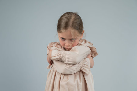 Portrait of a dissatisfied Caucasian girl on a white background