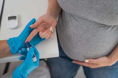 The doctor checks the blood sugar level of a pregnant patient. Gestational diabetesの写真素材