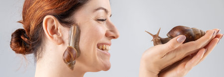 Close-up portrait of a Caucasian woman with whits on her face. The use of shellfish in cosmetologyの写真素材