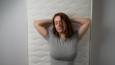 Top view of caucasian woman sleeping on mattressの写真素材