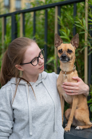 Young Caucasian woman and cute little dog walkingの写真素材