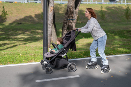Caucasian woman roller skating with her toddler son in a stroller
