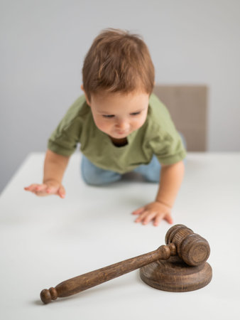 Little boy in front of a judges gavelの写真素材