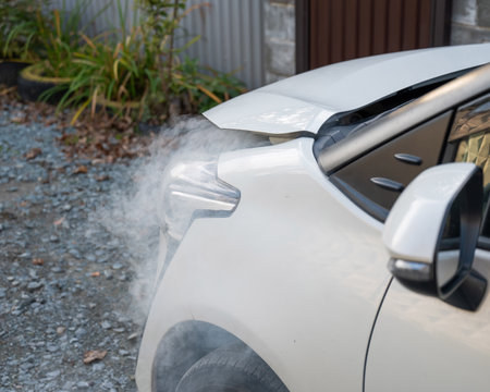 Smoke is coming from under the hood of the carの写真素材