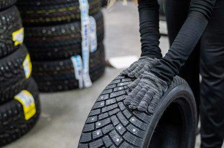 Mechanic keeps new studded car tires in garage