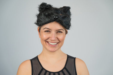 Portrait of a woman in a cat costume on a white background.の写真素材