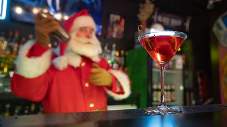 Santa Claus works at the bar making cocktails in a shakerの写真素材
