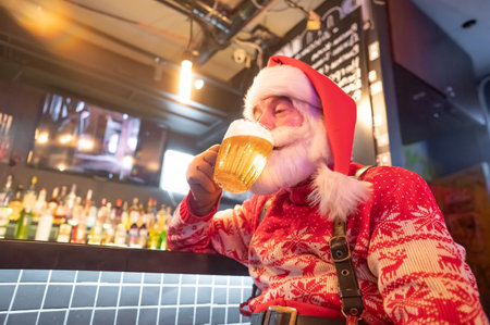 Santa Claus drinking beer at a barの写真素材