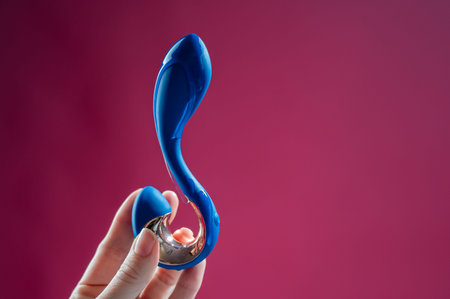 Lube pouring onto blue object on pink backgroundの写真素材