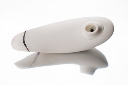 Clitoral vibrator on mirrored white surfaceの写真素材