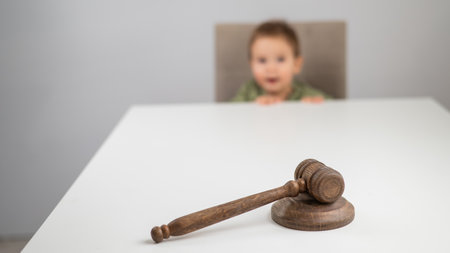 Little boy behind judges gavelの写真素材