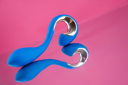 Blue sex toy on mirrored pink surfaceの写真素材