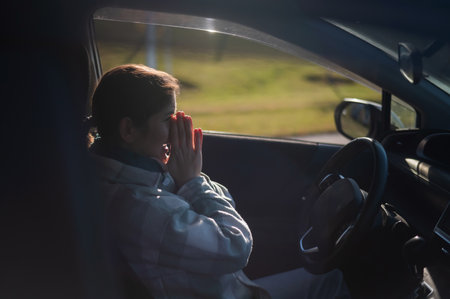 Caucasian woman cries while drivingの写真素材
