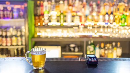 A mug of beer on the bar counter in a pub
