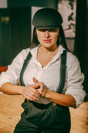 Caucasian woman in a mens suit posing in a retro gym