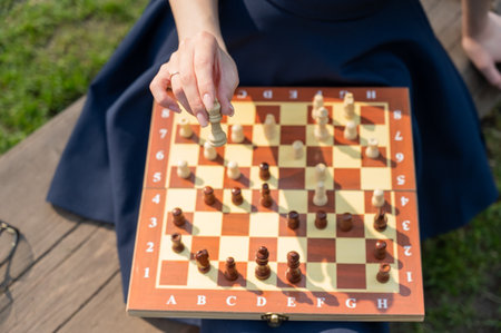 Caucasian woman playing chess outdoorsの写真素材