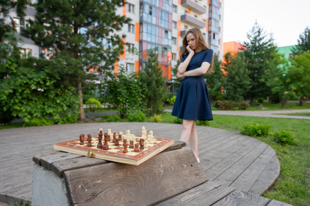 Caucasian woman playing chess outdoorsの写真素材