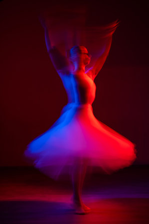 Woman dancing classical dance in tutu . Long exposure photo