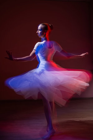 Caucasian woman dancing classical dance in tutu . Long exposure photoの写真素材