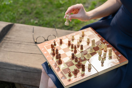 Caucasian woman playing chess outdoors