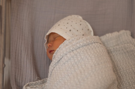 Newborn baby in diapers and a hat