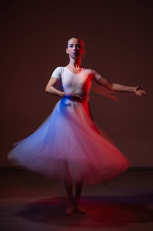 Woman dancing classical dance in tutu. Long exposure photoの写真素材