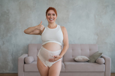 Happy Pregnant Woman Recommends Adult Diapersの写真素材