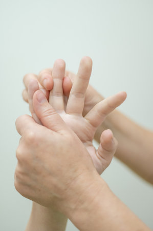 Close-up of female hands during massage. Vertical photoの写真素材