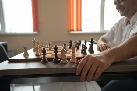 Caucasian man thinking about a chess moveの写真素材