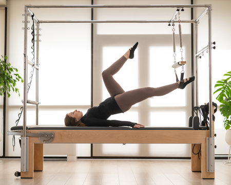Woman doing Pilates on reformerの写真素材